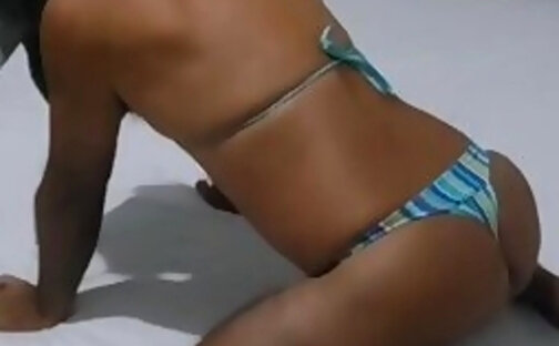 Latina crossdress LadyPamela in bed showing off her hot ass in bikini on webcam