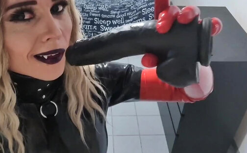 Sexy skinny Latex Vamp Girl makes video call with a friend
