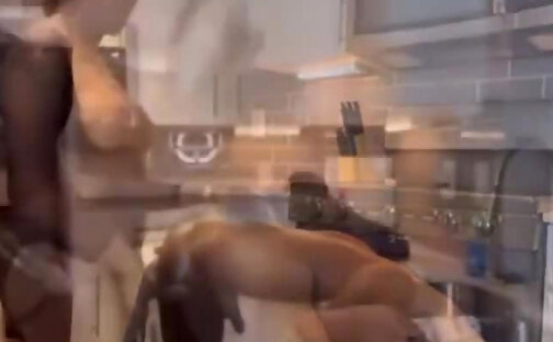 Busty black tranny fucking a dude's ass in the kitchen